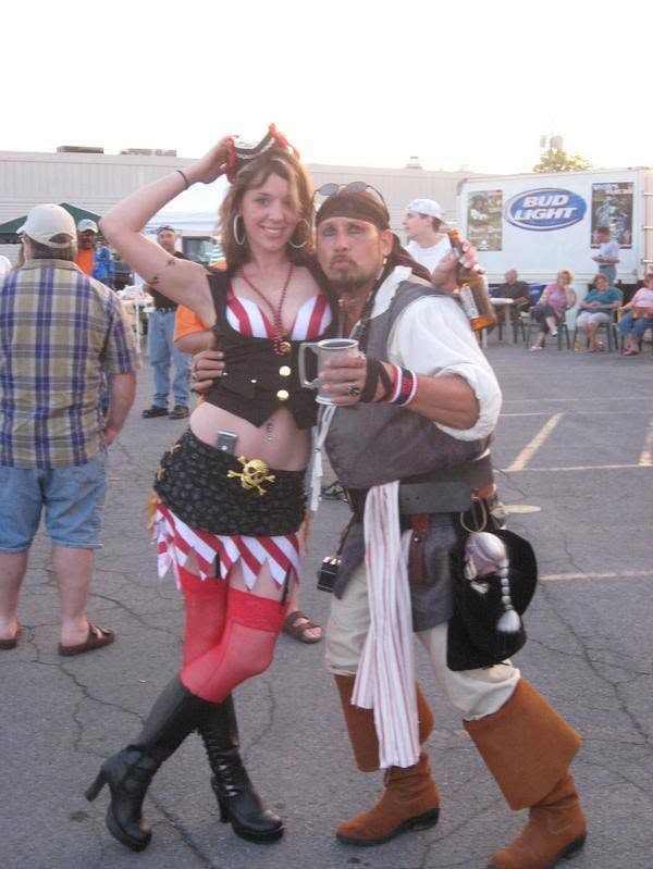 Woody's Pirate Party — pirate wench and Jack Sparrow lookalike posing in parking lot with Bud Light truck
