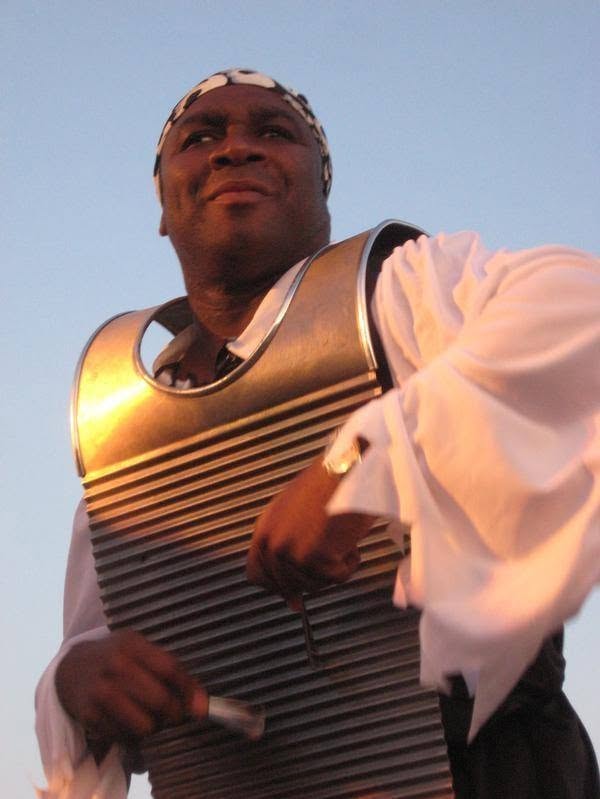 Woody's Pirate Party — washboard player in pirate costume performing on outdoor stage at dusk closeup