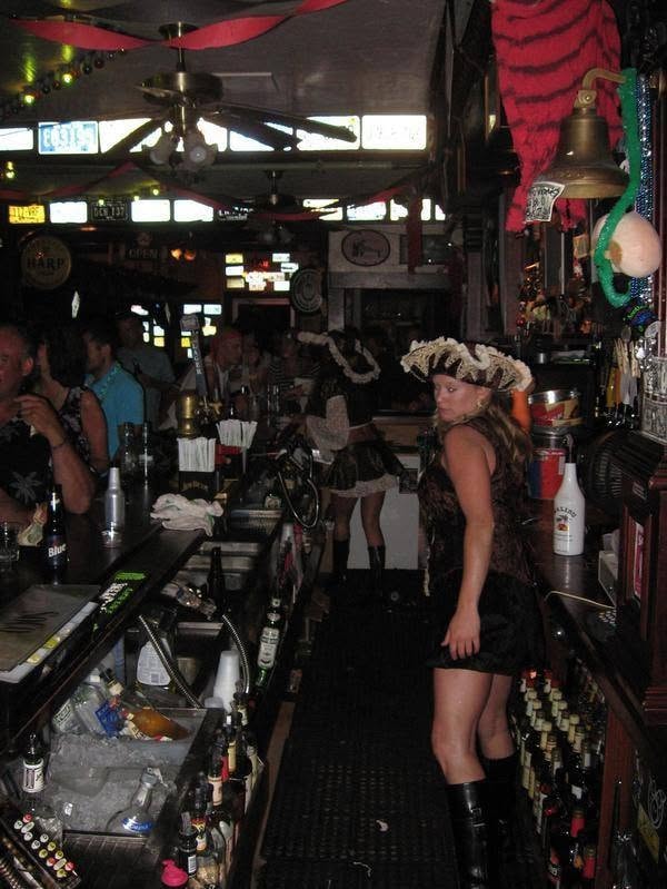 Woody's Pirate Party — bartender in pirate hat working the full bar inside Woody's decorated for the event