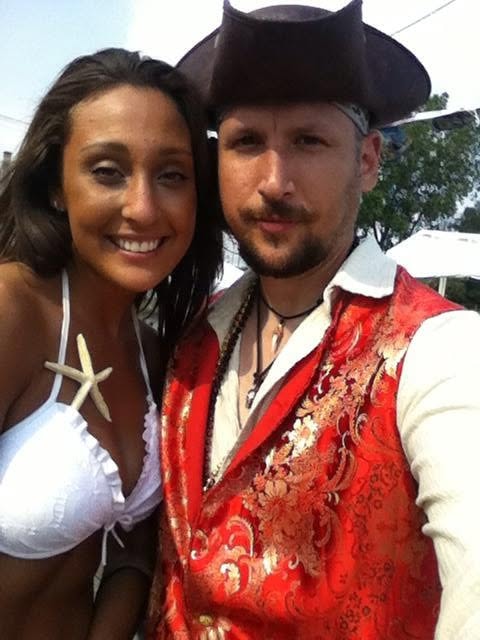 Woody's Pirate Party — woman with starfish accessory and man in red brocade pirate vest selfie outdoors