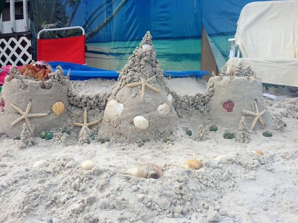 Woody's Pirate Party — elaborate sand castle decorated with starfish and seashells at tropical beach set
