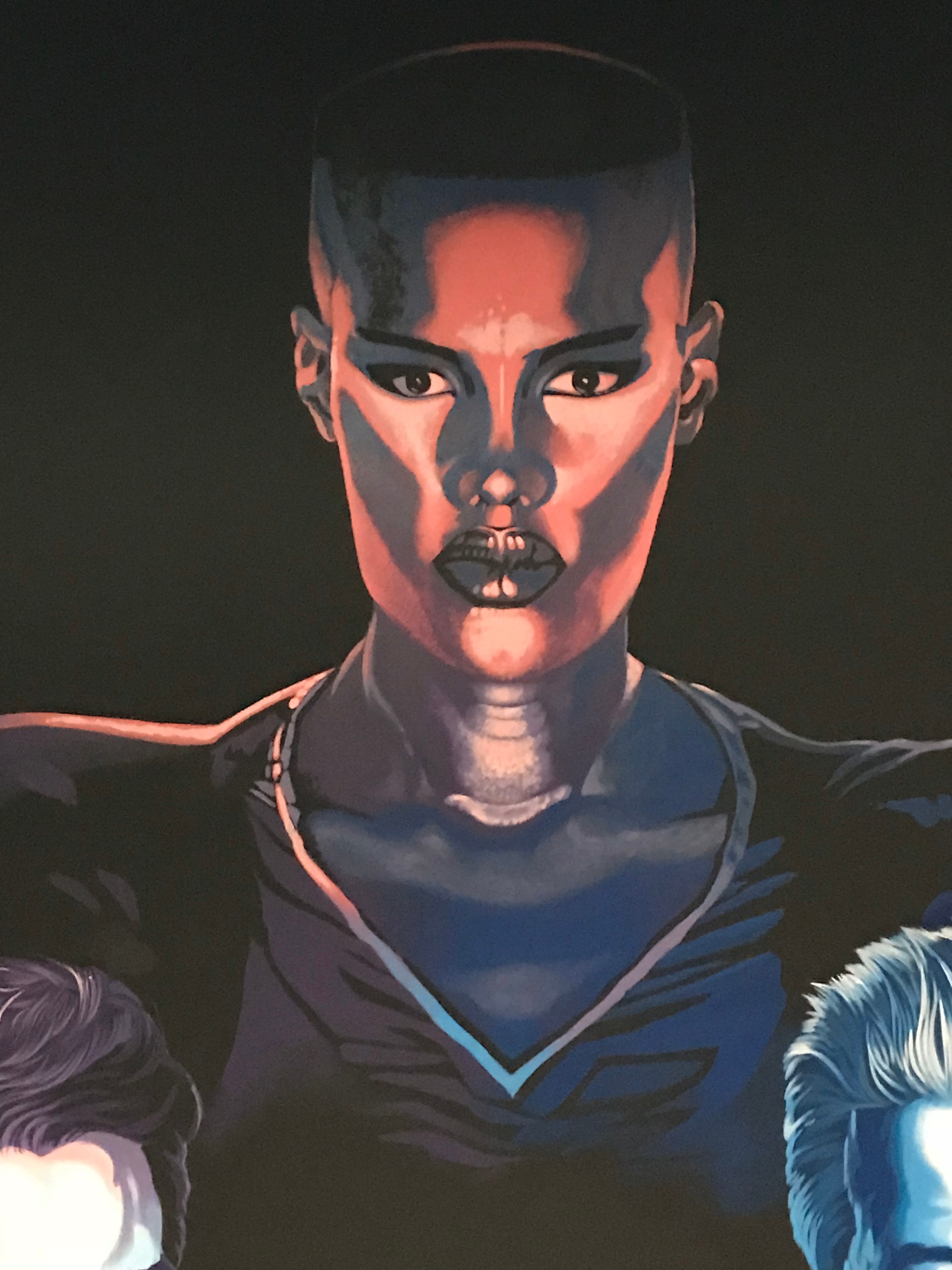 Club 11 mural detail — Grace Jones portrait close-up with dramatic red and blue lighting against black background