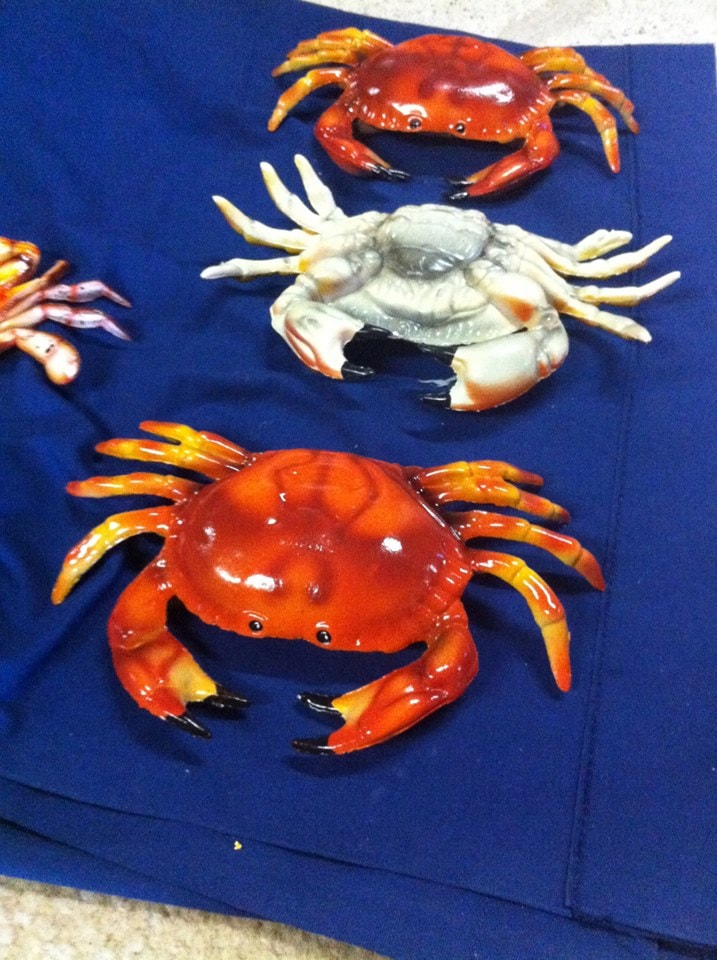 Painted crab sculptures on blue