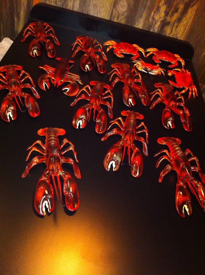 Painted crawdads installed on black ceiling tray