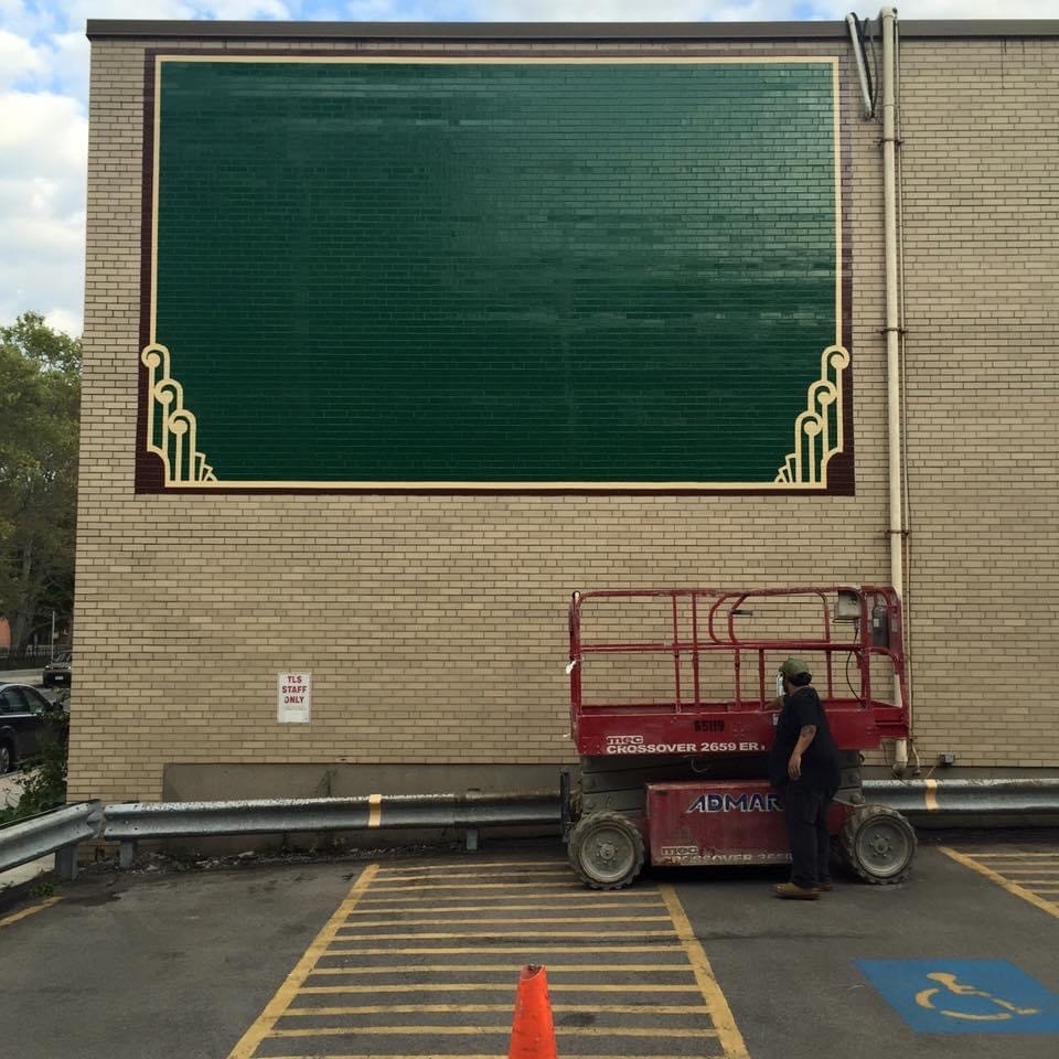 Art Deco gold border and corner scroll ornaments complete — full green field painted, frame finished