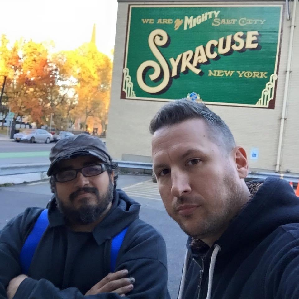 Wide-angle final shot of the completed "We Are the Mighty Salt City — Syracuse, New York" mural