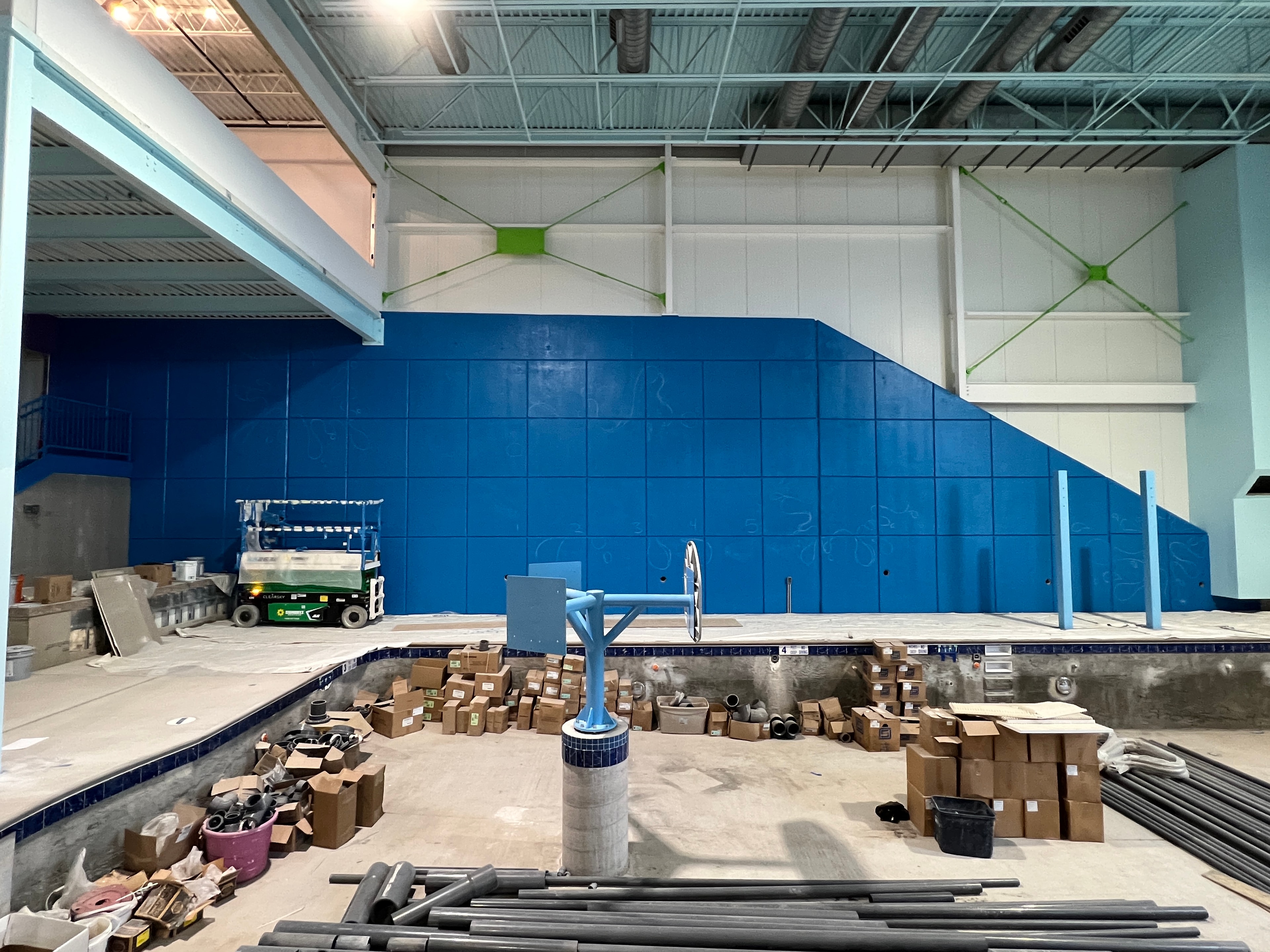 Blank blue wall at Splash Indoor Water Park — the 1,900 sq ft bridge foundation surface before work began