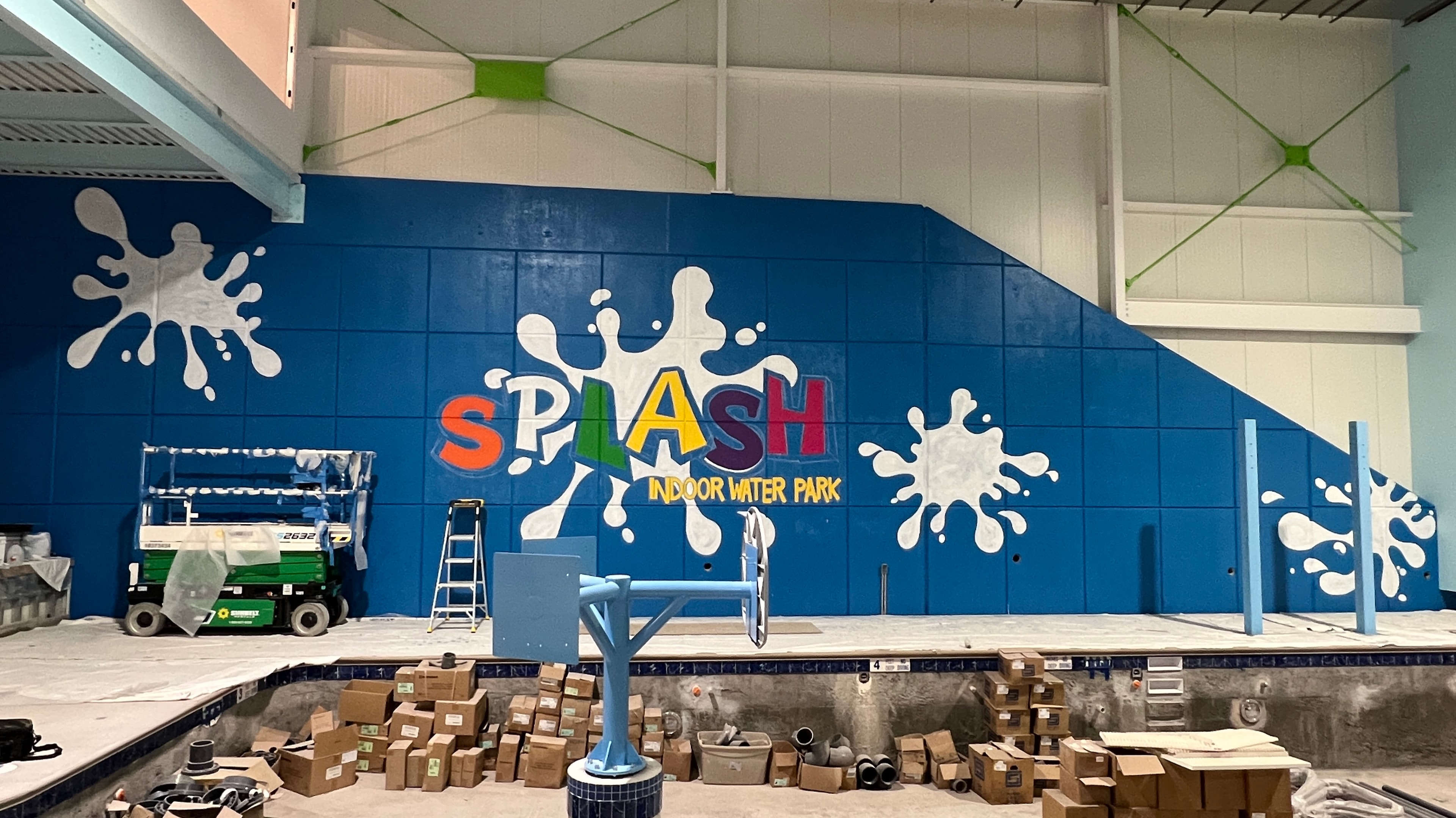 Color in progress — SPLASH logo with multi-color lettering and white splash graphics, full wall view