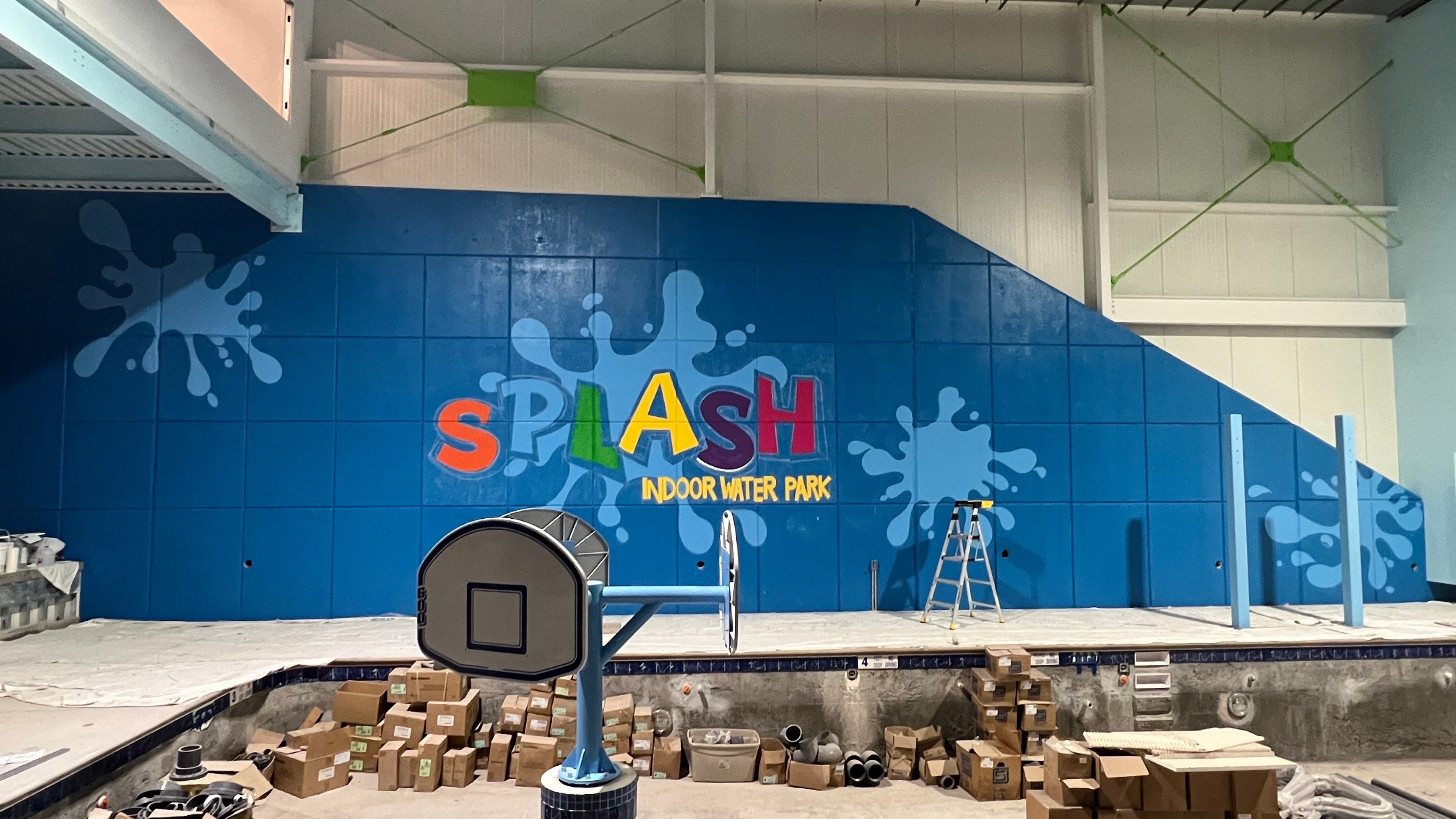 Color detail — close-up of the completed SPLASH Indoor Water Park lettering with light blue splash background