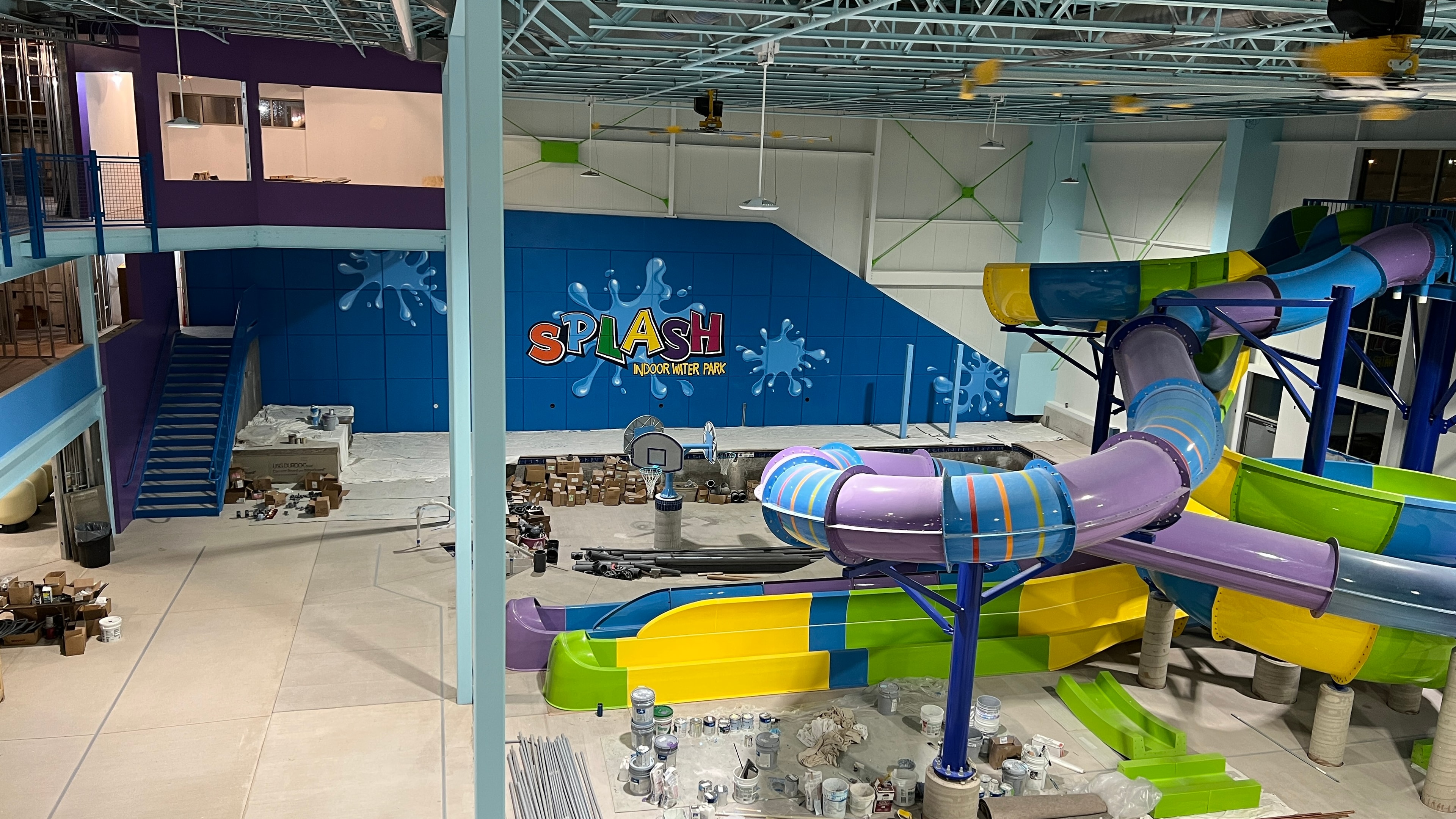 Overhead view of the completed Splash Indoor Water Park facility with water slides and mural visible in background
