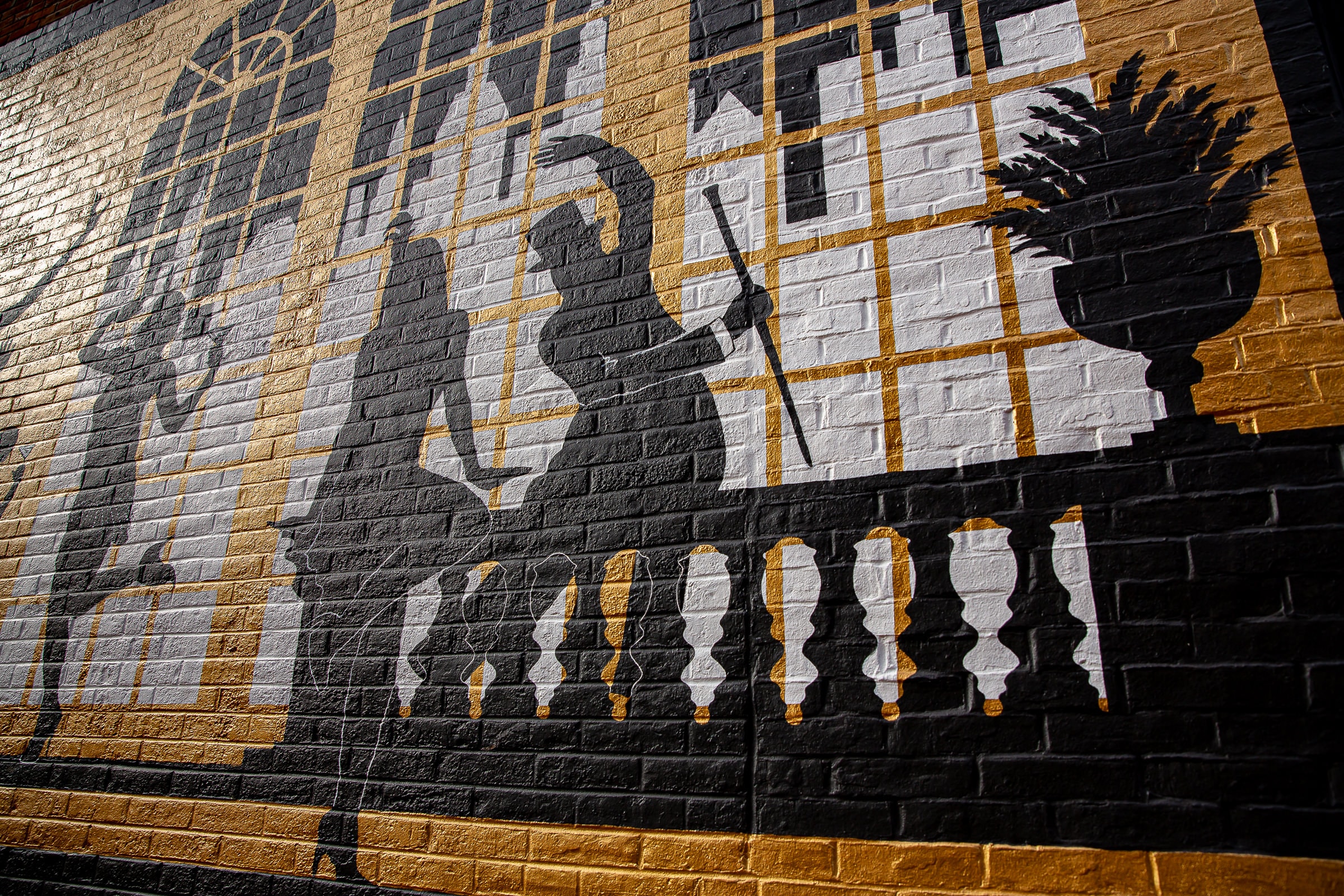 Silhouette figures on balcony — gold and black